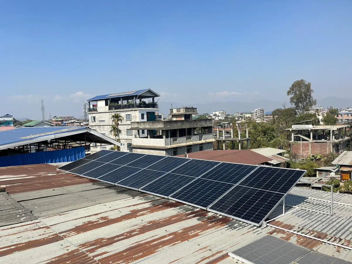 Rooftop solar installation overlooking the Imphal skyline near Ima Keithel