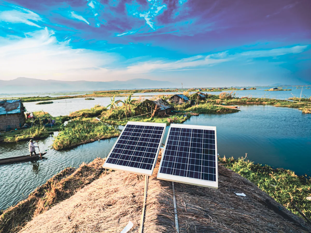 Solar panels on the thatched roof of a floating home on Loktak Lake, Manipur